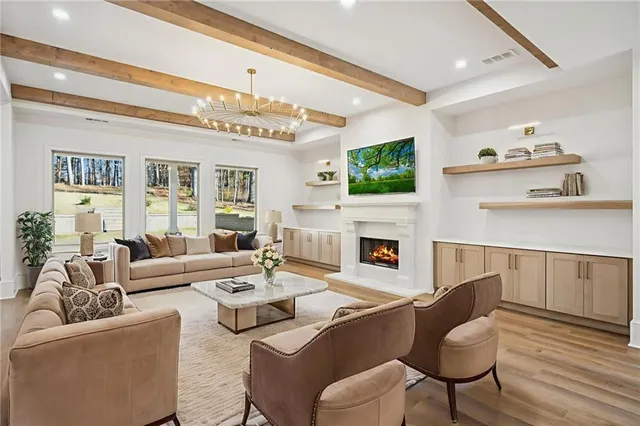 a large white kitchen with a large window a oven and a counter space
