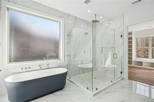 a bedroom with a large bed and a flat screen tv