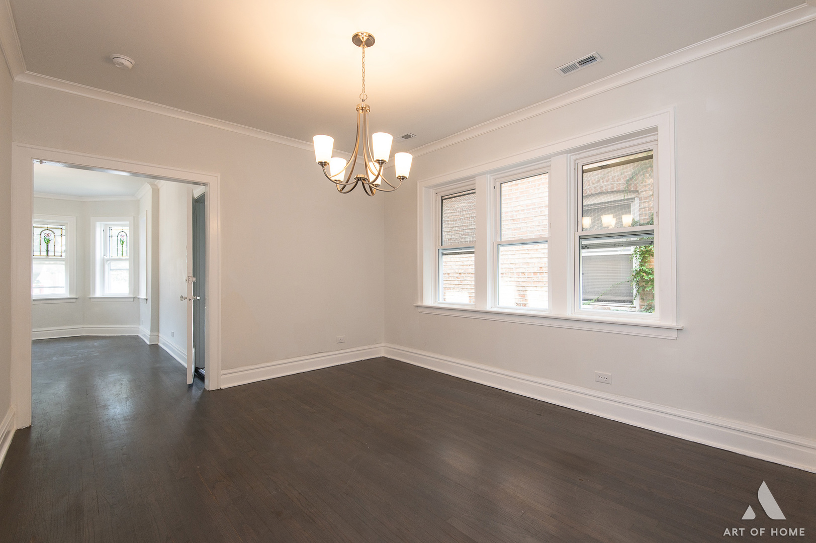 1820 Gunderson Avenue, Unit 3 Berwyn, IL 60402 - Photo 5 of 17 an empty room with wooden floor chandelier and windows