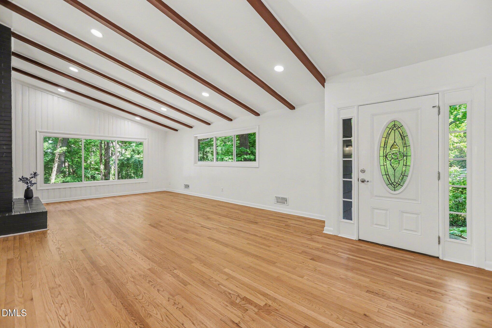 2600 Wade Avenue Raleigh, NC 27607 - Photo 4 of 31 an empty room with wooden floor and windows