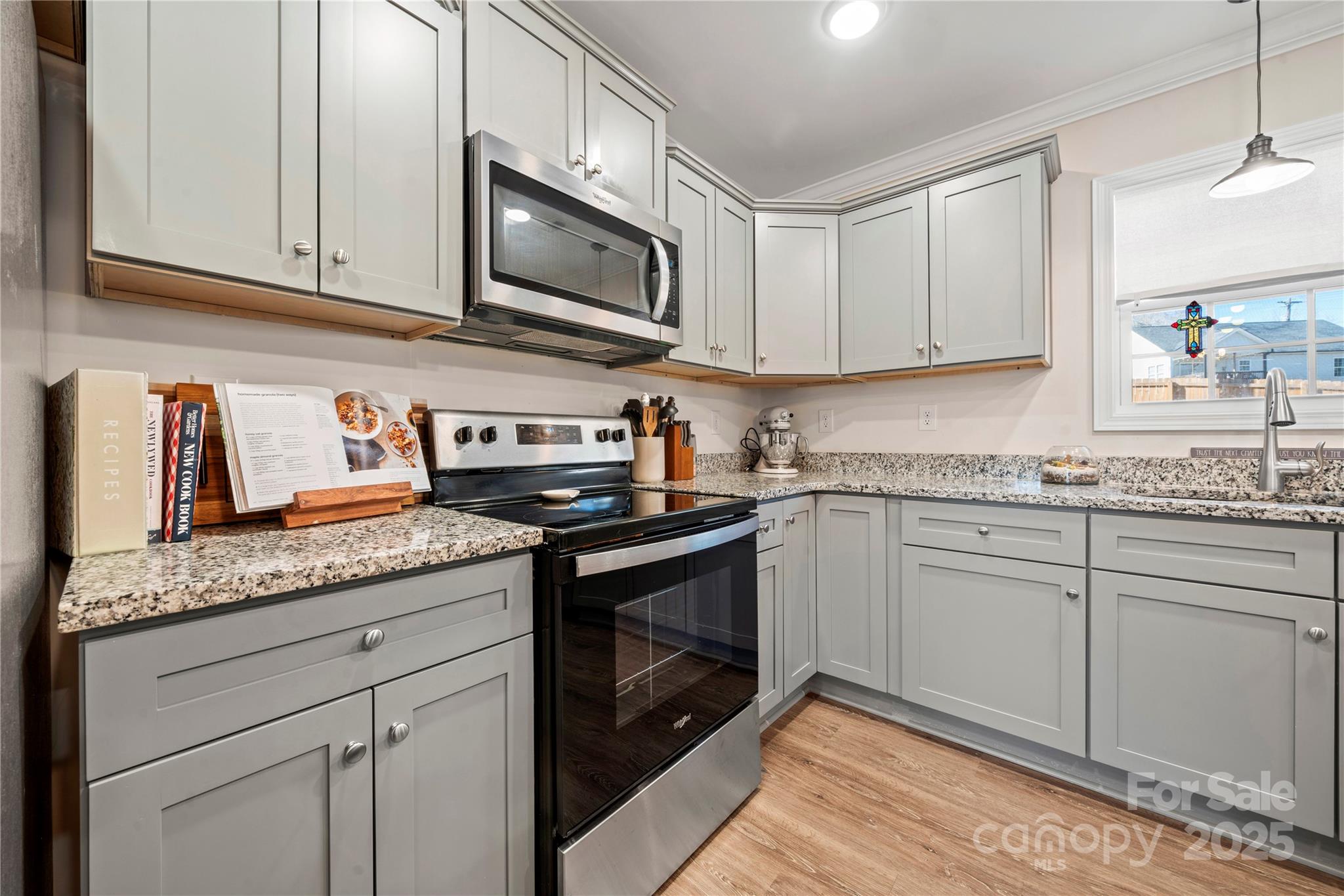 131 Lowry Row, Unit 8 York, SC 29745 - Photo 13 of 32 a kitchen with granite countertop stainless steel appliances white cabinets granite counter tops and a wooden floors