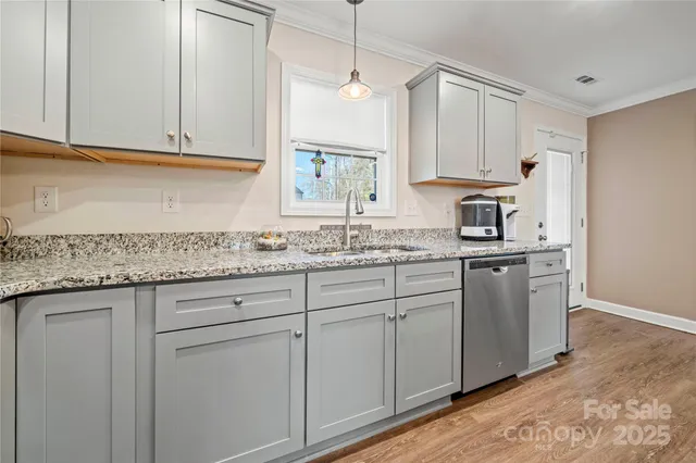 a kitchen with granite countertop cabinets stainless steel appliances and a sink