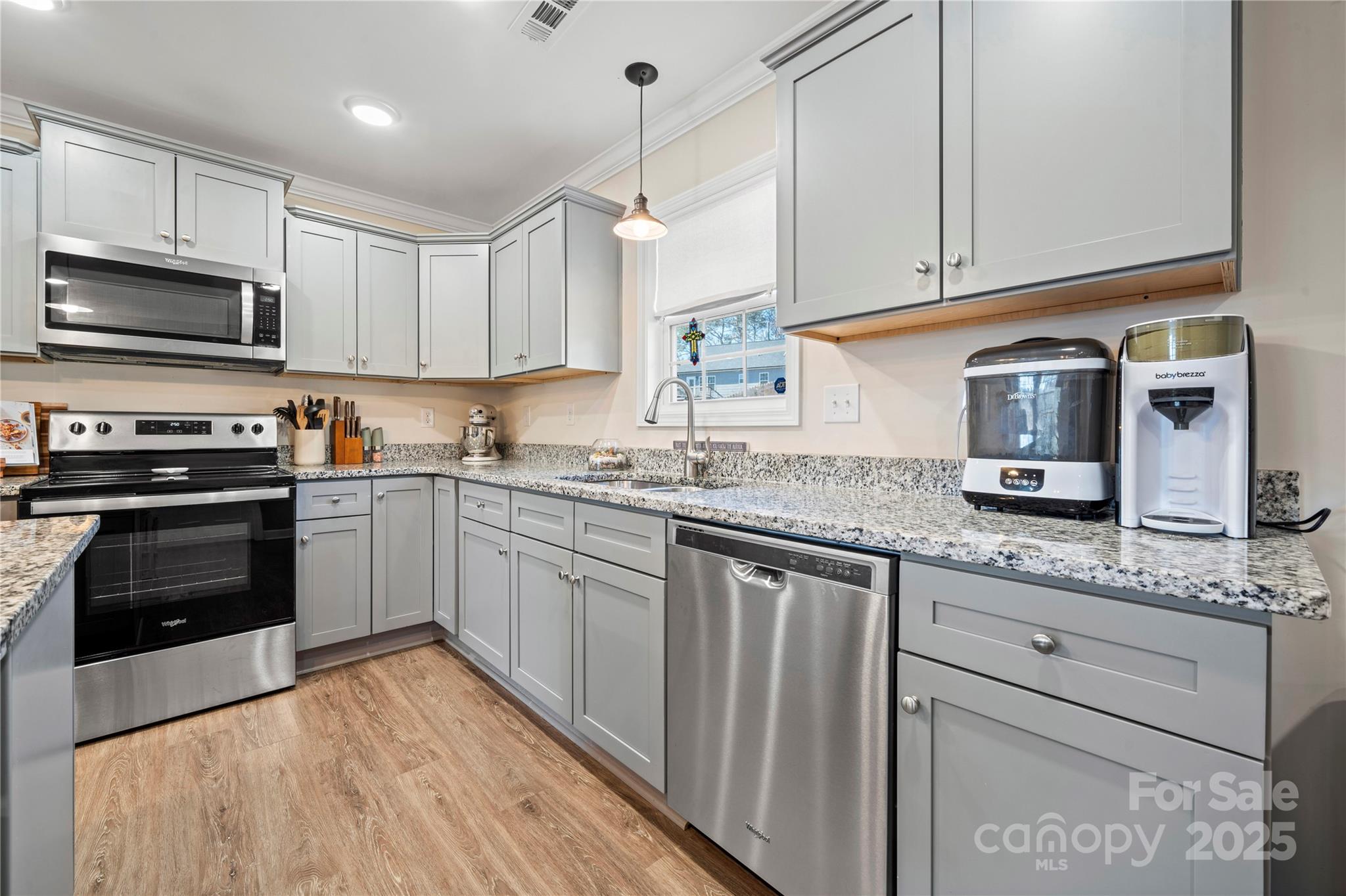 131 Lowry Row, Unit 8 York, SC 29745 - Photo 15 of 32 a kitchen with stainless steel appliances granite countertop a stove a sink and a microwave
