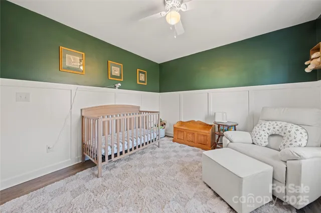 a bedroom with furniture and a lamp