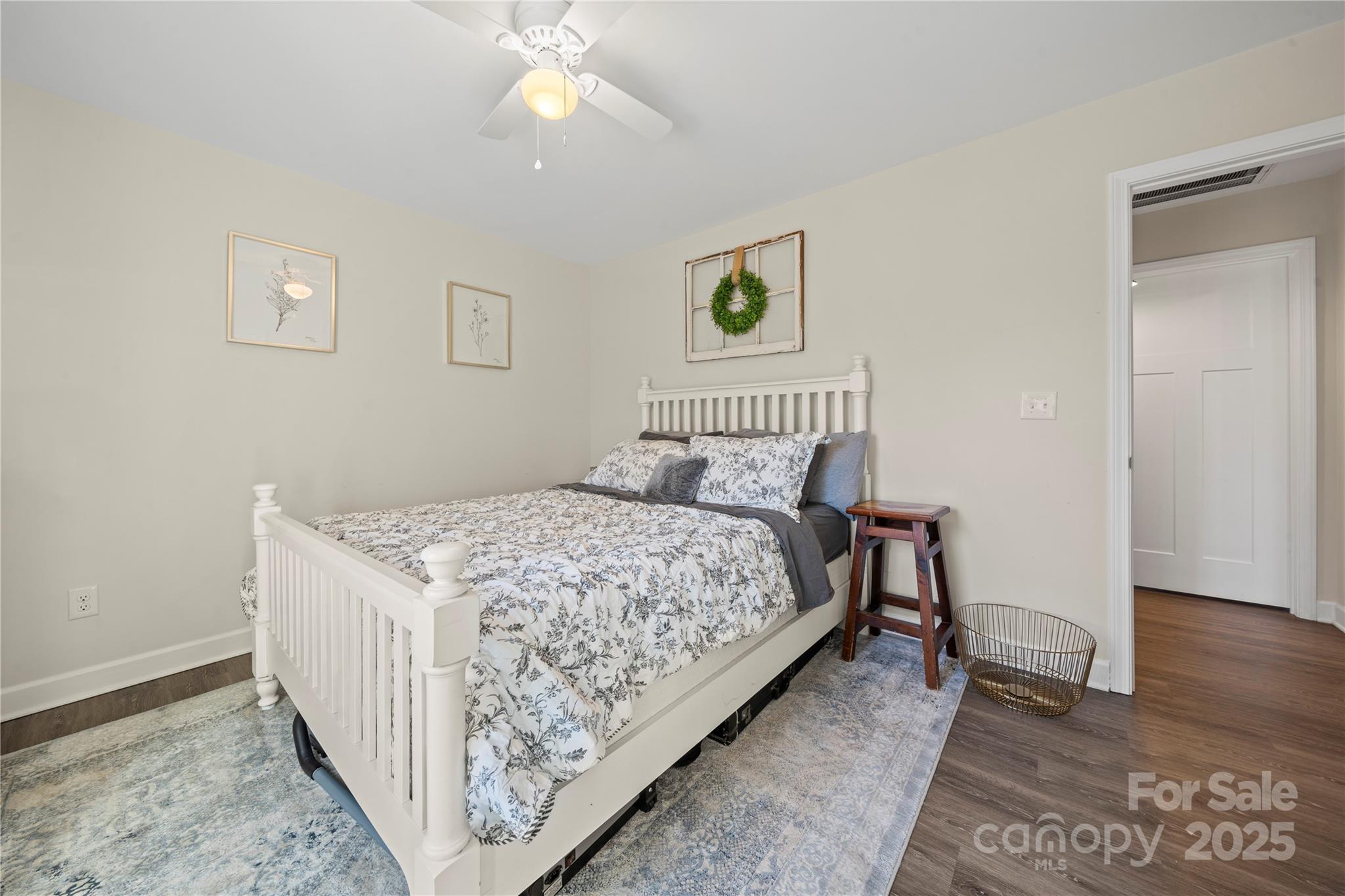 131 Lowry Row, Unit 8 York, SC 29745 - Photo 23 of 32 a bedroom with a bed and wooden floor