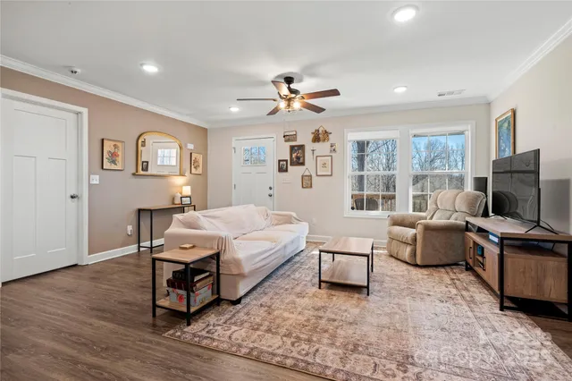 a spacious bedroom with a bed and a flat screen tv