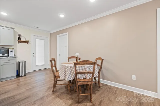 a dining room with furniture and wooden floor