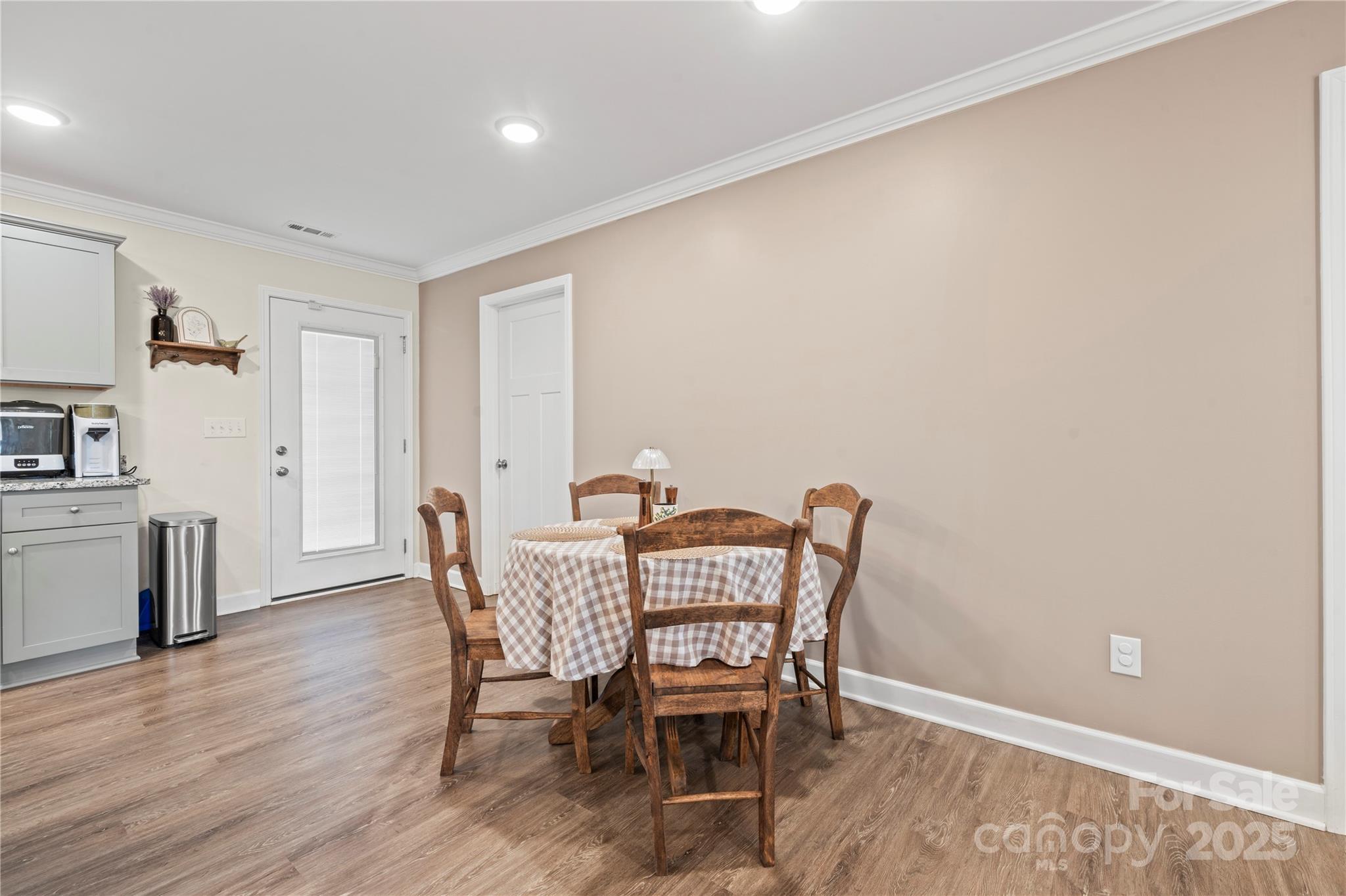131 Lowry Row, Unit 8 York, SC 29745 - Photo 7 of 32 a dining room with furniture and wooden floor