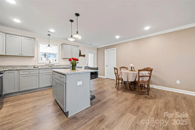 a kitchen with a sink cabinets and wooden floor
