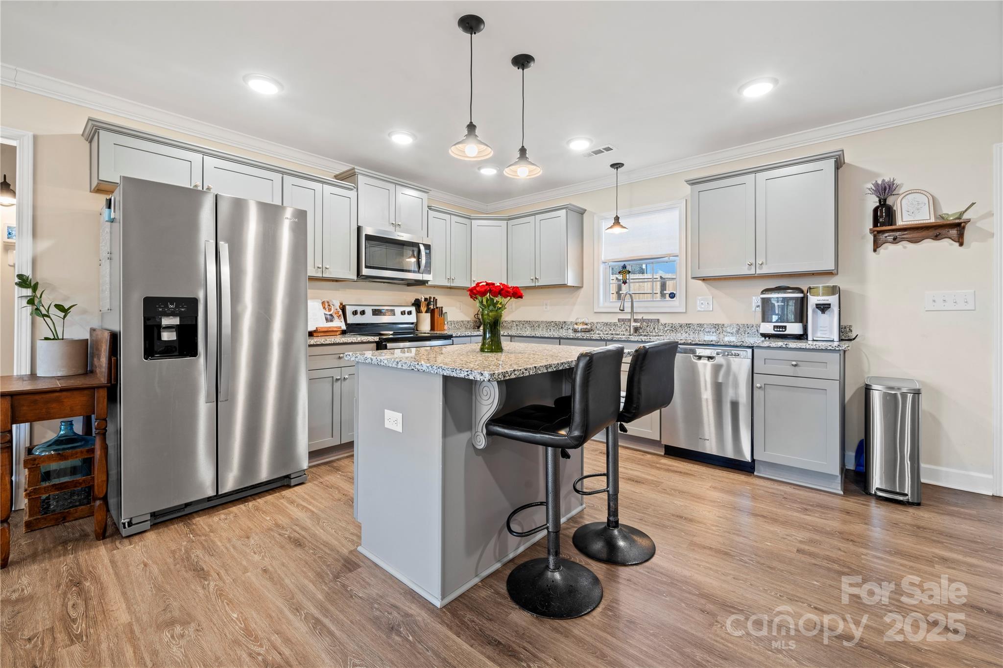 131 Lowry Row, Unit 8 York, SC 29745 - Photo 9 of 32 a kitchen with stainless steel appliances granite countertop a refrigerator a stove a sink dishwasher and white cabinets with wooden floor