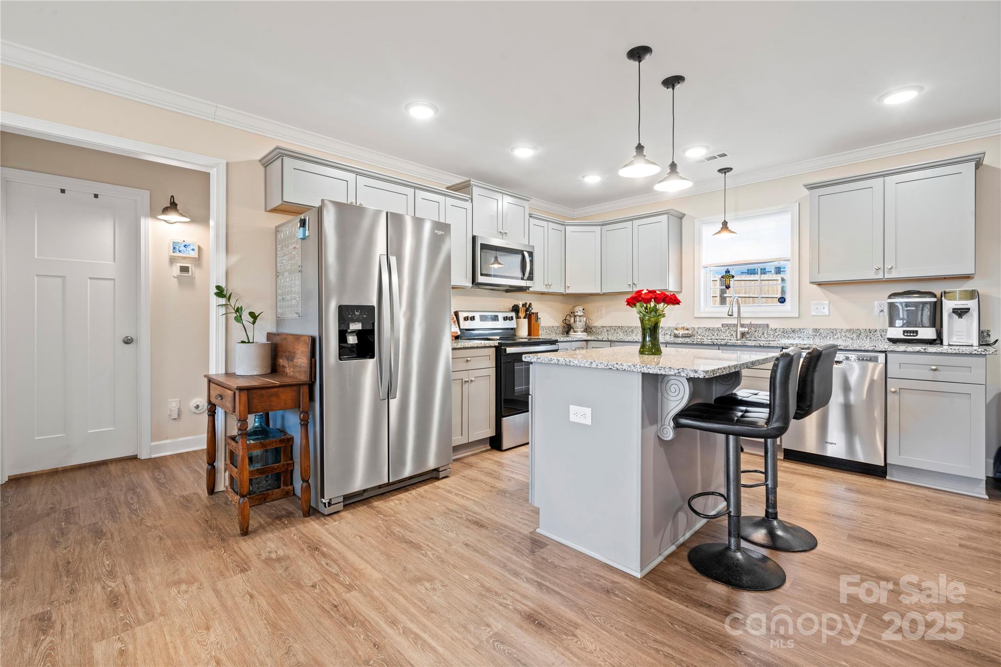 131 Lowry Row, Unit 8 York, SC 29745 - Photo 10 of 32 a kitchen with a sink a refrigerator and wooden floor