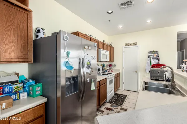 a kitchen with stainless steel appliances granite countertop a refrigerator and a stove