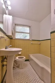 a bathroom with a sink a toilet and bathtub