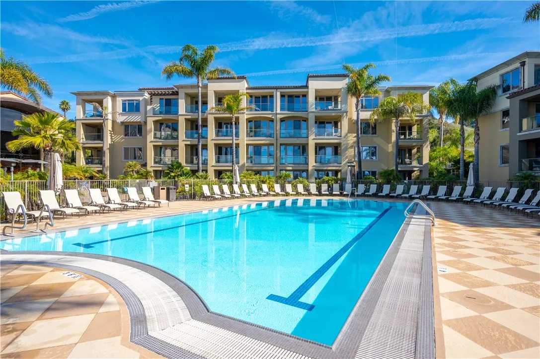 a view of a swimming pool with outdoor seating