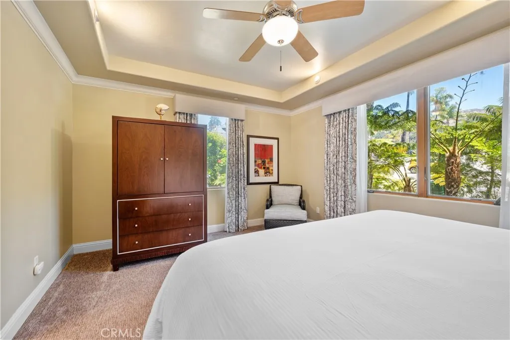 2727 Shell Beach Road Pismo Beach, CA 93449 - Photo 14 of 44 a bedroom with a bed and a chandelier