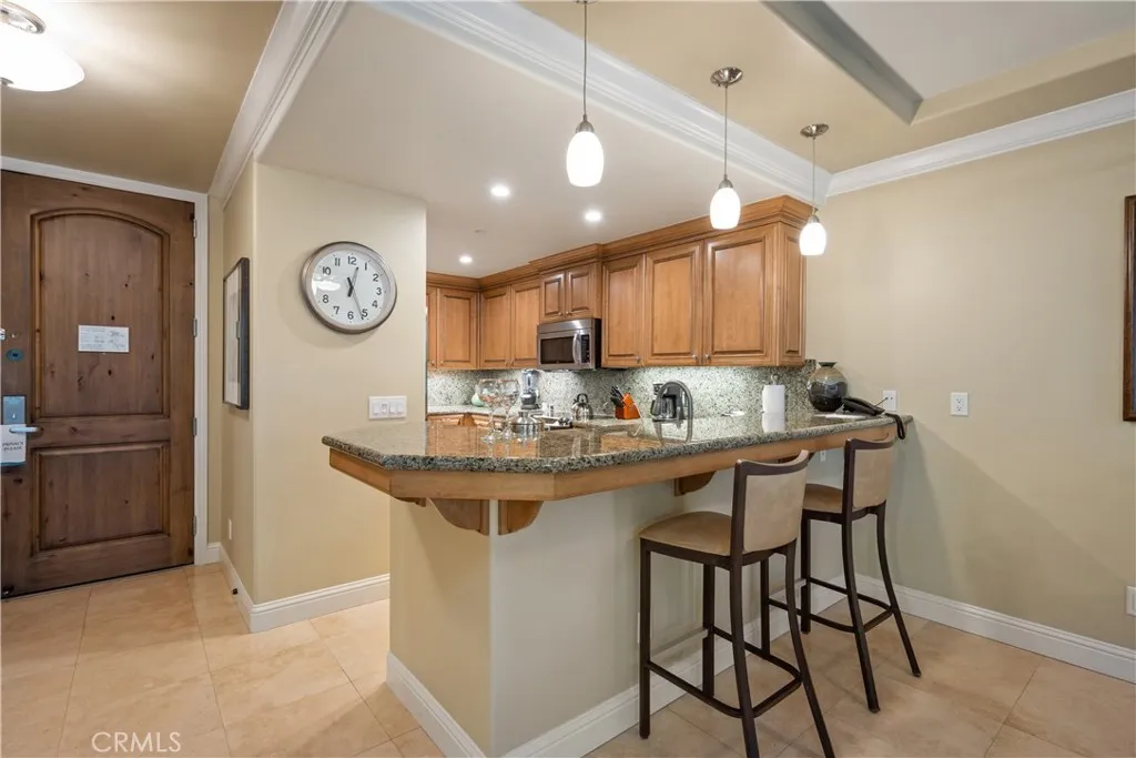 2727 Shell Beach Road Pismo Beach, CA 93449 - Photo 8 of 44 a kitchen with a table and chairs in it