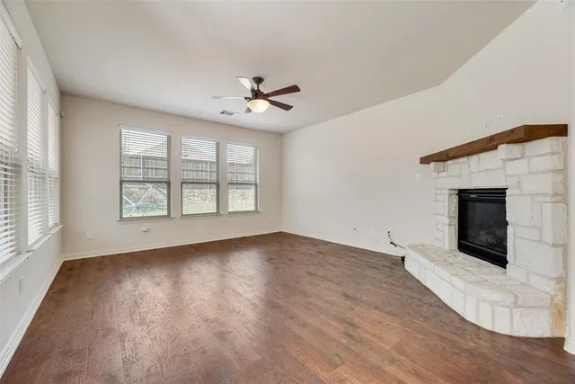 a view of kitchen with kitchen island white cabinets and stainless steel appliances
