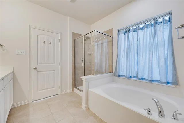 a view of an empty room with chandelier fan