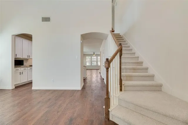 a view of entryway and hall with wooden floor
