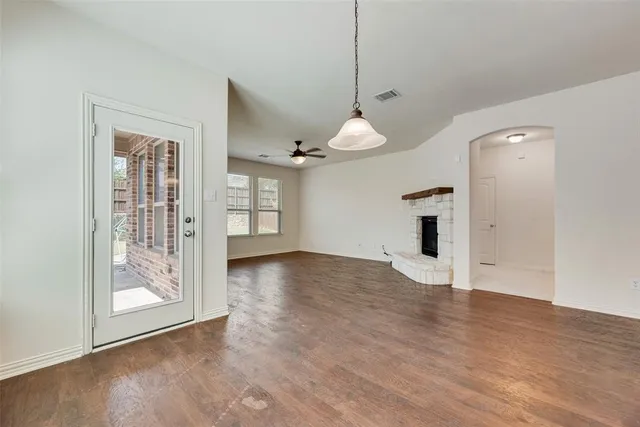 a kitchen that has a sink a stove and a wooden floor