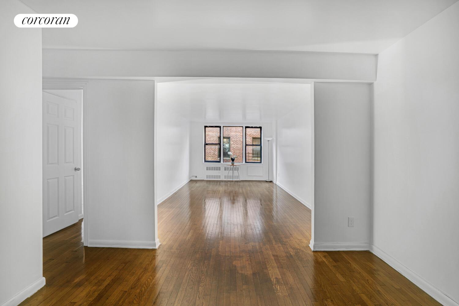 330 Lenox Road, Unit 6S Brooklyn, NY 11226 - Photo 5 of 14 a view of an empty room with wooden floor and a window