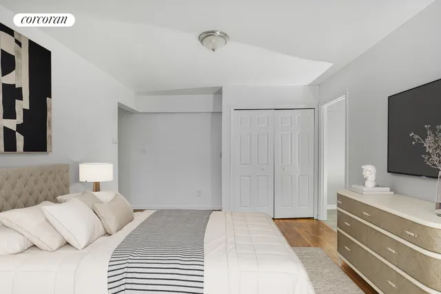 a bedroom with a bed and a flat screen tv