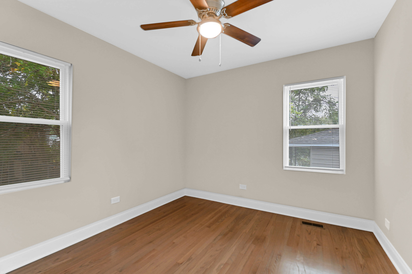 703 West 129th Place Chicago, IL 60628 - Photo 24 of 29 a view of an empty room with wooden floor and a window