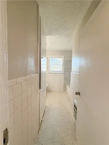 a bathroom with a toilet sink vanity and mirror