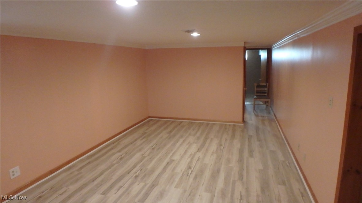 2901 Dentzler Road Parma, OH 44134 - Photo 19 of 25 Unfurnished room with light wood-style floors, ornamental molding, and recessed lighting