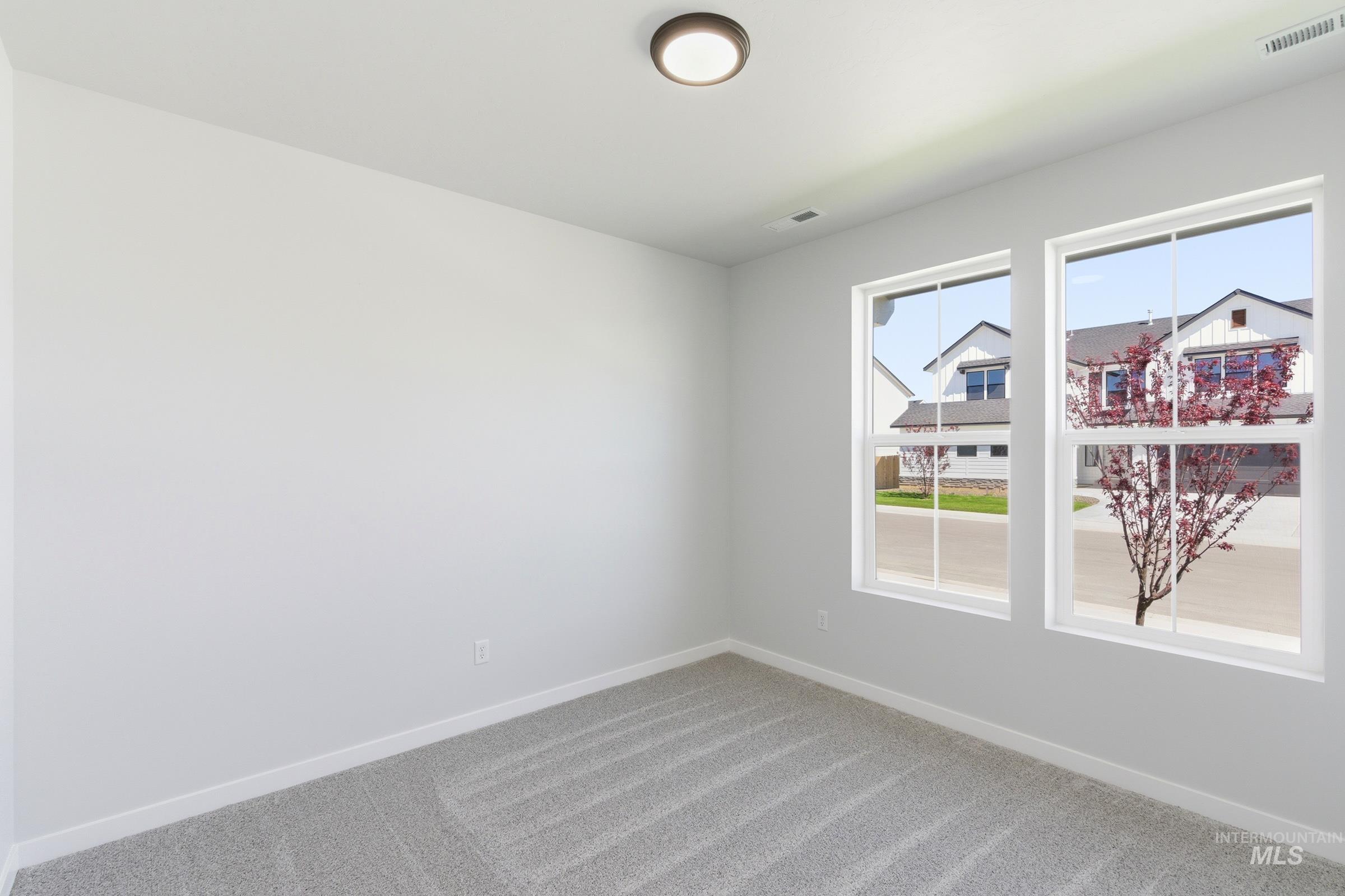 13663 Redway Court Caldwell, ID 83607 - Photo 18 of 32 Neutral-toned interior room featuring light gray carpeting and white baseboards