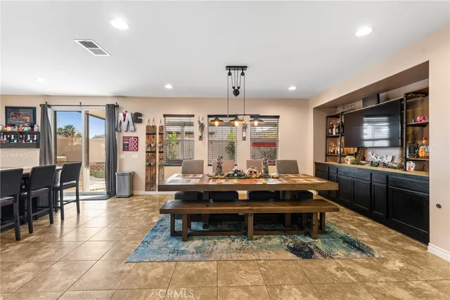 a living room with furniture a flat screen tv and a large window