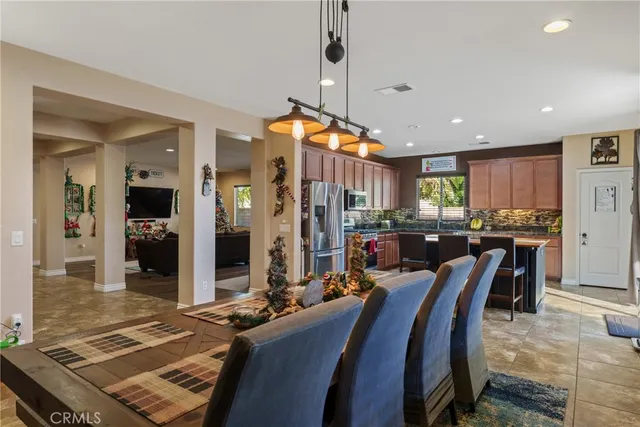 a very nice looking dining room with kitchen island furniture and a chandelier