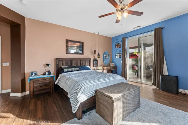 a spacious bedroom with a bed and a chandelier