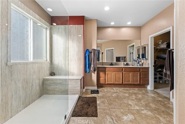 a bathroom with a tub sink and mirror
