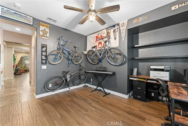 a view of a workspace with furniture and wooden floor