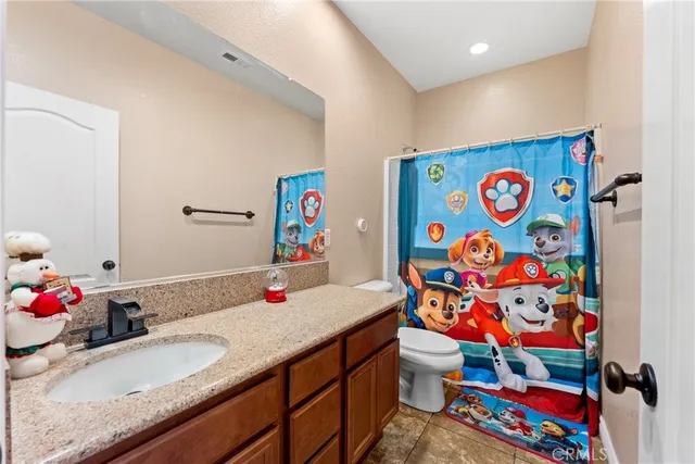 a bathroom with a sink a vanity and toilet