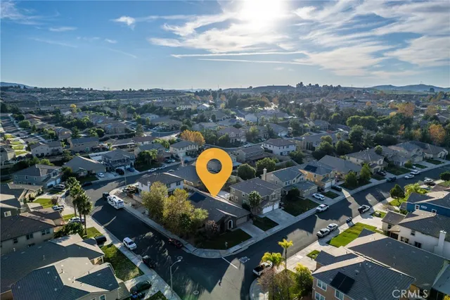 an aerial view of a house with a swimming pool yard and mountain view in back