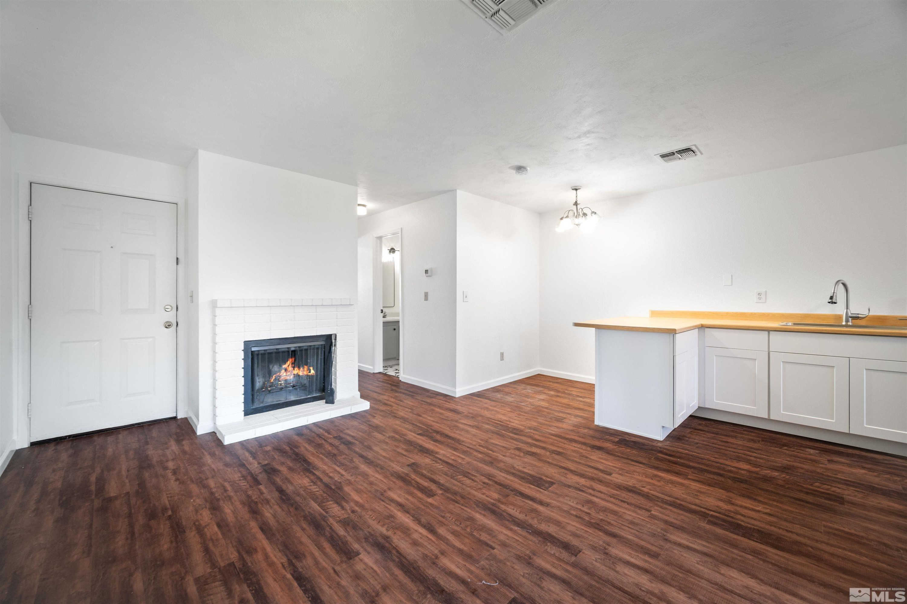 4769 Reggie Road, Unit 254 Reno, NV 89502 - Photo 6 of 23 a view of a kitchen with wooden floor and a fireplace