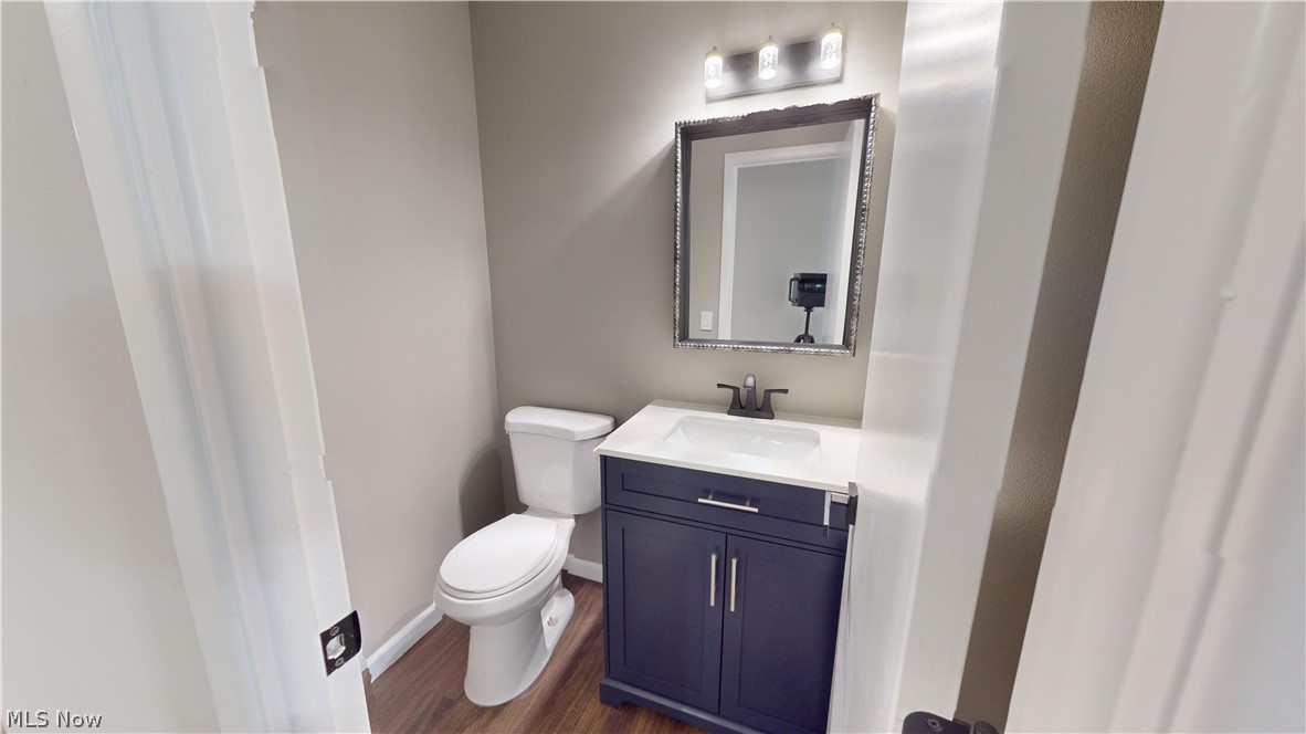 1224 Cordova Road Mayfield Heights, OH 44124 - Photo 15 of 29 Bathroom with vanity, toilet, and hardwood / wood-style floors