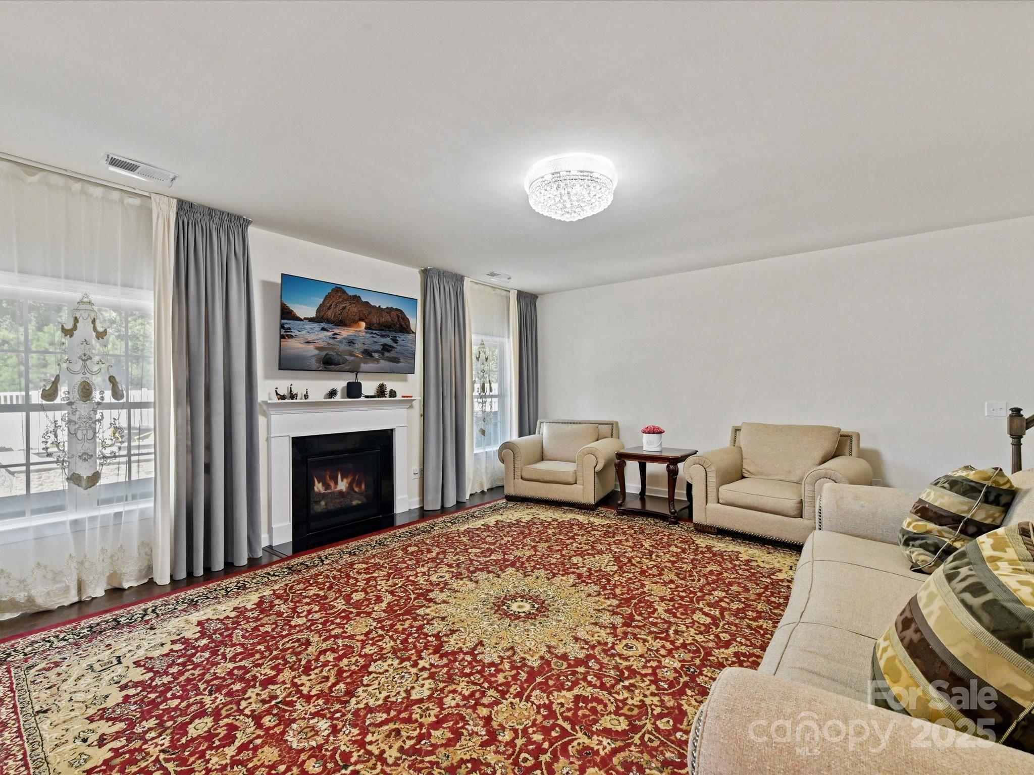 9890 Travertine Trail Davidson, NC 28036 - Photo 15 of 45 a bedroom with furniture and a fireplace