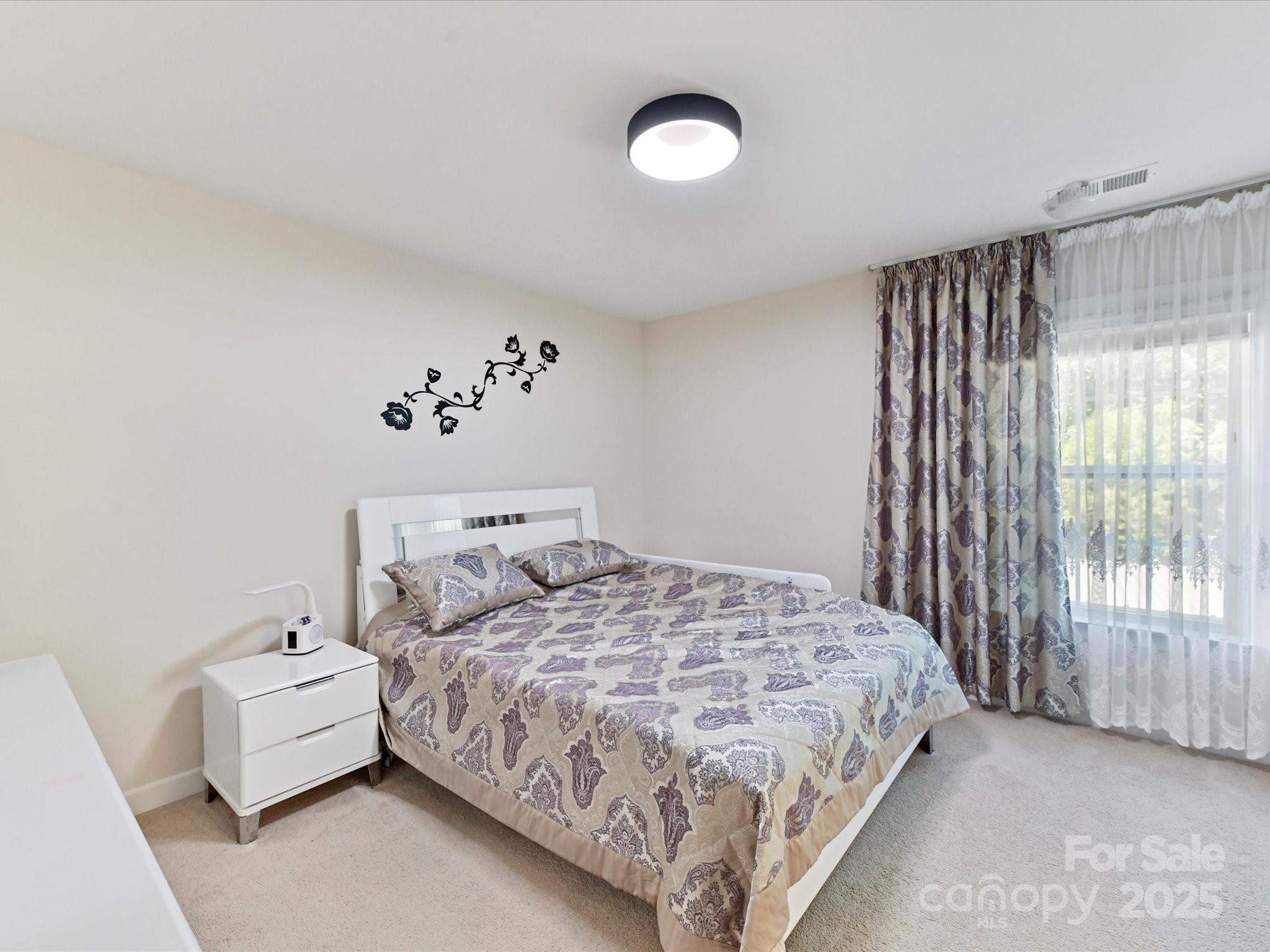 9890 Travertine Trail Davidson, NC 28036 - Photo 20 of 45 a bedroom with a bed and a couch