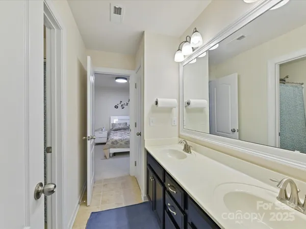a bathroom with a sink a vanity and a mirror