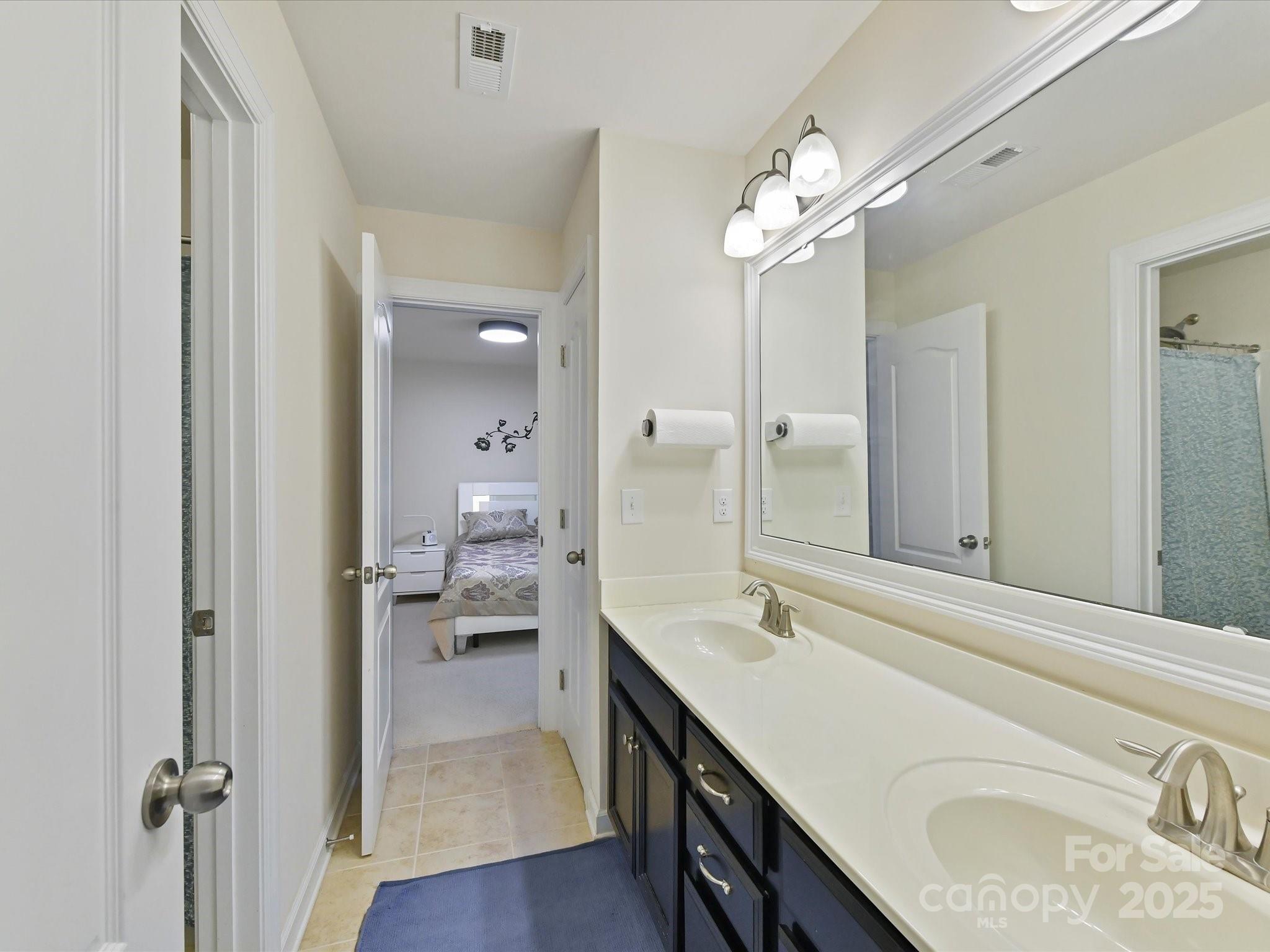 9890 Travertine Trail Davidson, NC 28036 - Photo 22 of 45 a bathroom with a sink a vanity and a mirror