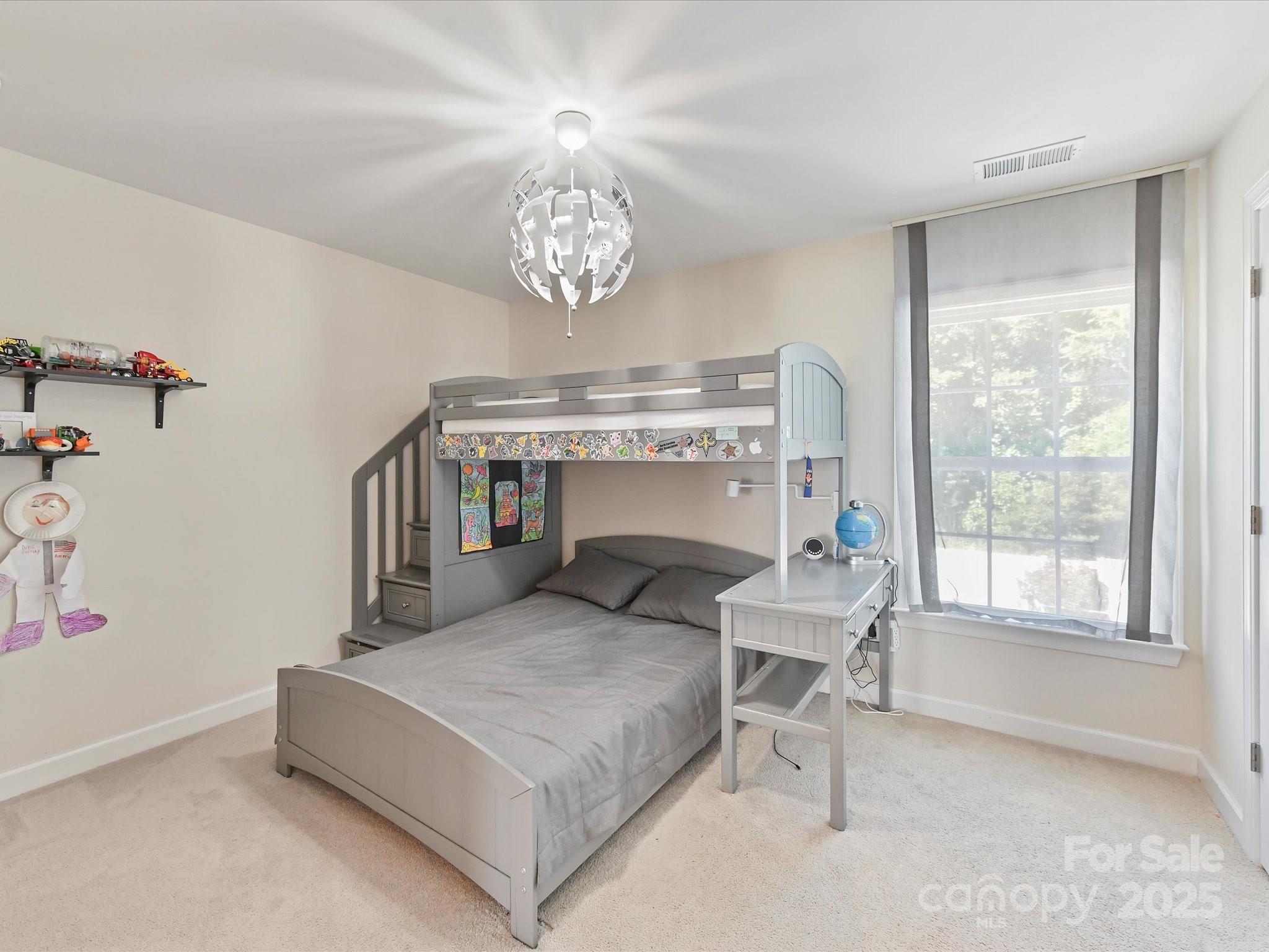 9890 Travertine Trail Davidson, NC 28036 - Photo 26 of 45 a bedroom with a bed and a chandelier