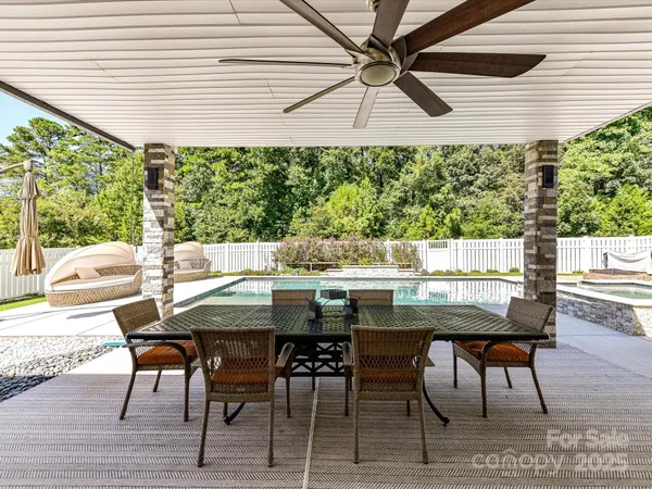 a view of a patio with a table and chairs