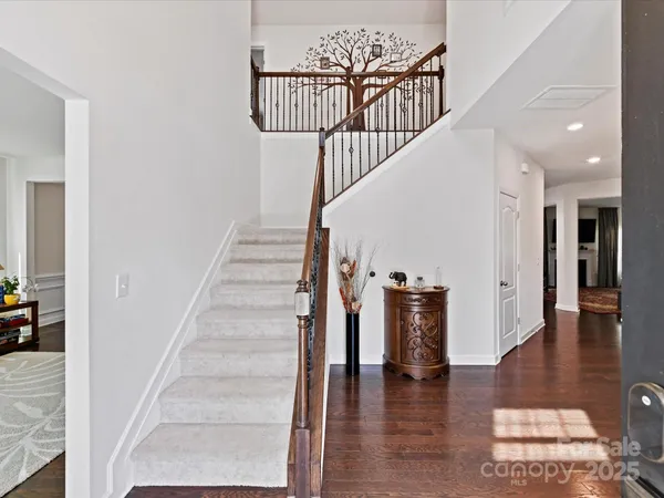 a view of entryway and hall with wooden floor
