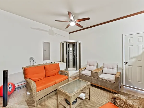 a living room with furniture a rug and a chandelier