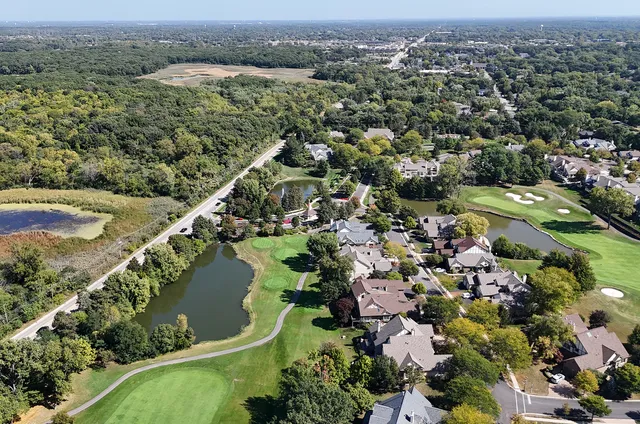 an aerial view of lake residential houses with outdoor space and trees