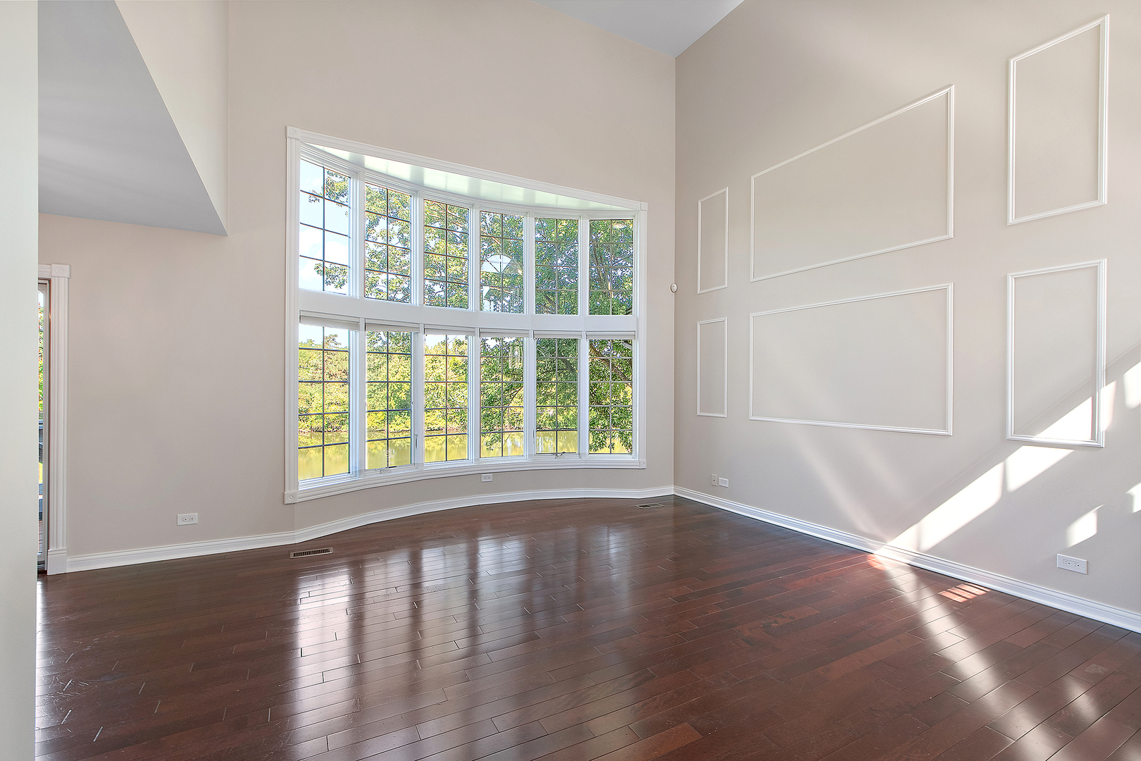 10534 Golf Road Orland Park, IL 60462 - Photo 4 of 54 a view of an empty room with wooden floor and a window