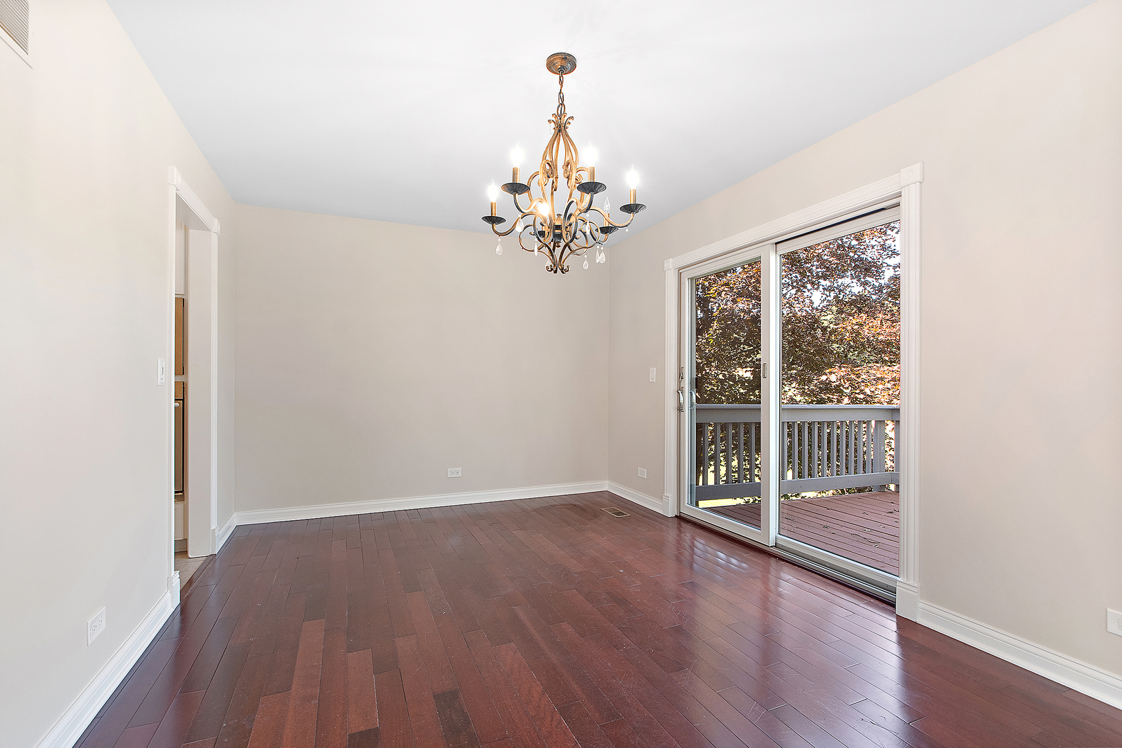 10534 Golf Road Orland Park, IL 60462 - Photo 6 of 54 an empty room with wooden floor chandelier and windows